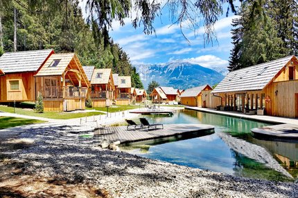 Hotel & Glamping Ribno Alpine Resort © Katarina Strgar Ferienhütten am See mit Bergblick und Sonnenliegen