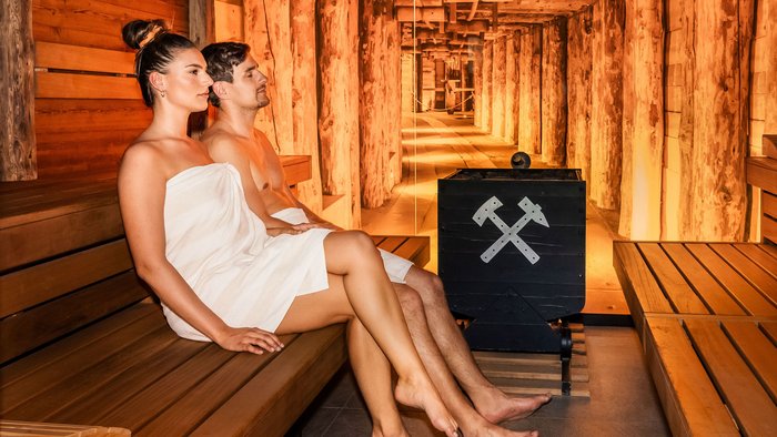 Landrefugium Obermüller – aktiver Rückzug im Rennradrefugium
© Stefan J. Wolf Photography Mann und Frau entspannen zusammen in einer Holzsauna mit warmem Licht