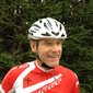 Roman Erlacher © Sporthotel Exclusive SAS Man wearing white helmet and red cycling jersey by pine trees