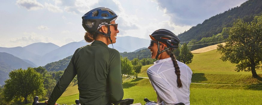 Bucklige Welt © NOEW Mayerhofer Zwei Frauen mit Fahrrädern in ländlicher, bergiger Landschaft