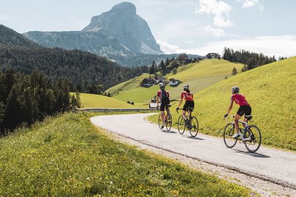 Marmolada © Alex Moling Three cyclists riding on a mountain road with alpine scenery